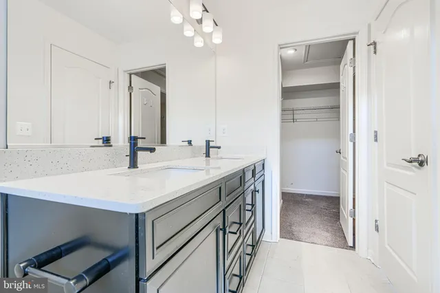 a bathroom with a sink vanity and a mirror