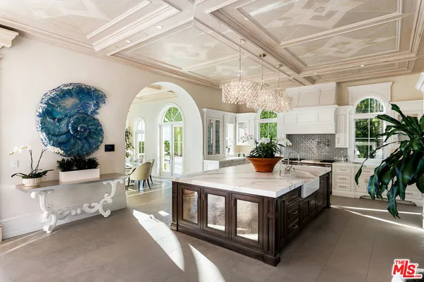 a view of a dining room with furniture and a chandelier