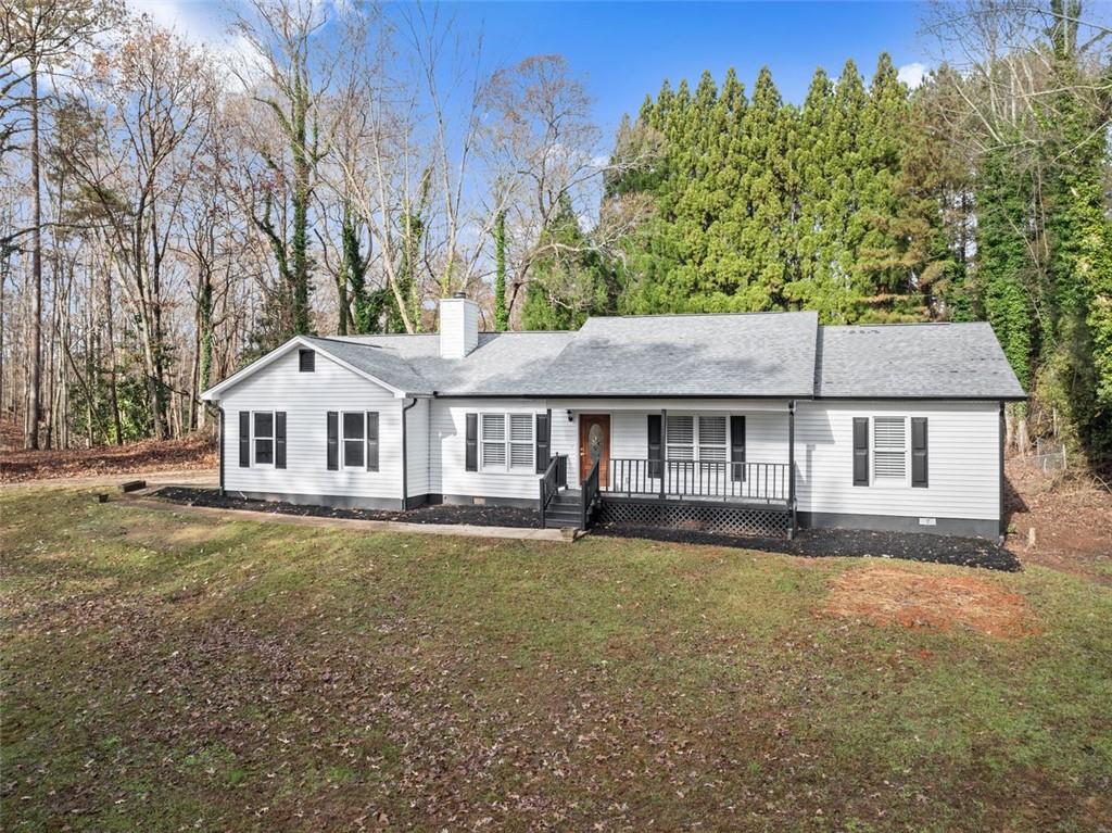 a front view of a house with a garden