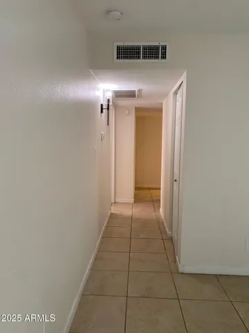 an empty room with a ceiling fan and window