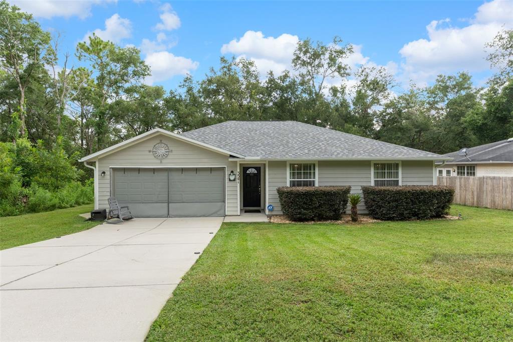 a front view of a house with yard and garage