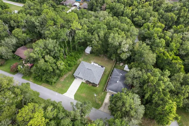 an aerial view of a house with garden space and street view