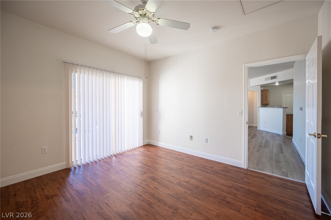 8555 West Russell Road, Unit 2062 Las Vegas, NV 89113 - Photo 21 of 35 Hardwood-style flooring and a sliding glass door define this bright, versatile living area.