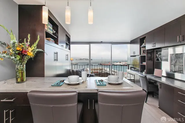 a dining room with furniture and a floor to ceiling window
