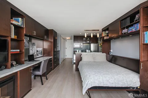 a bedroom with a large bed and a large window