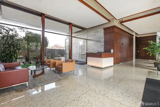 a front view of a house with a garden and plants