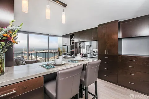 a kitchen with stainless steel appliances kitchen island granite countertop a sink stove and refrigerator