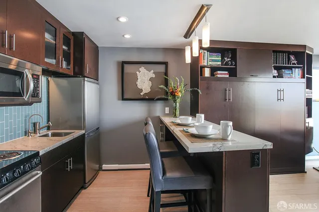 a kitchen with stainless steel appliances granite countertop a stove and a refrigerator
