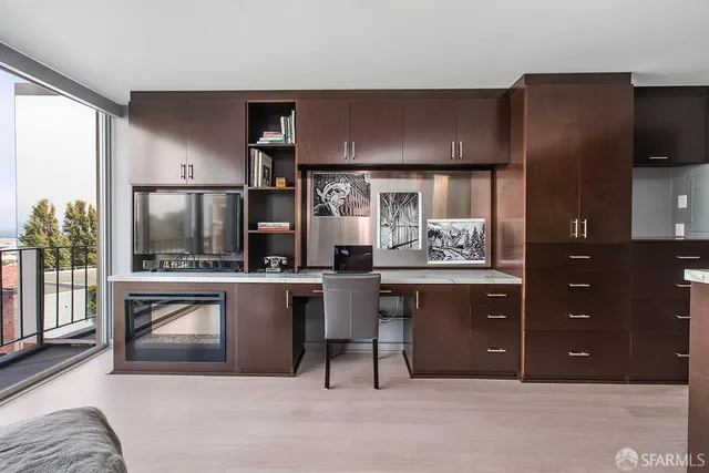 a view of a kitchen with a sink and wooden floor
