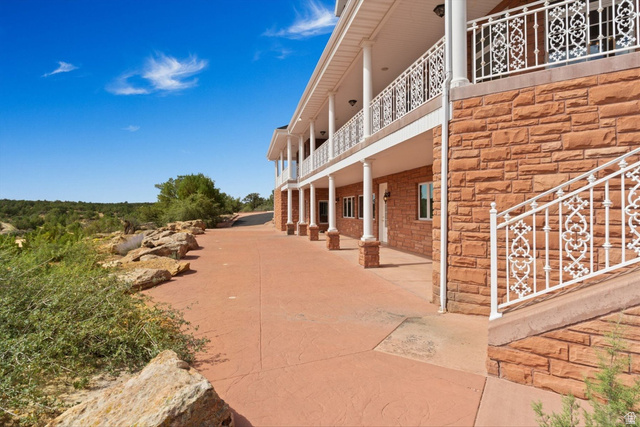 5615 East Eight Mile Gap Road Kanab, UT 84741 - Photo 59 of 81 View of home's exterior featuring a balcony and stone siding