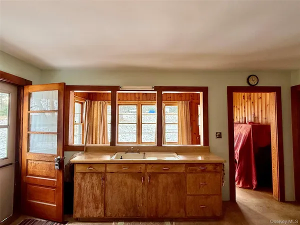 a living room with furniture fireplace and a large window