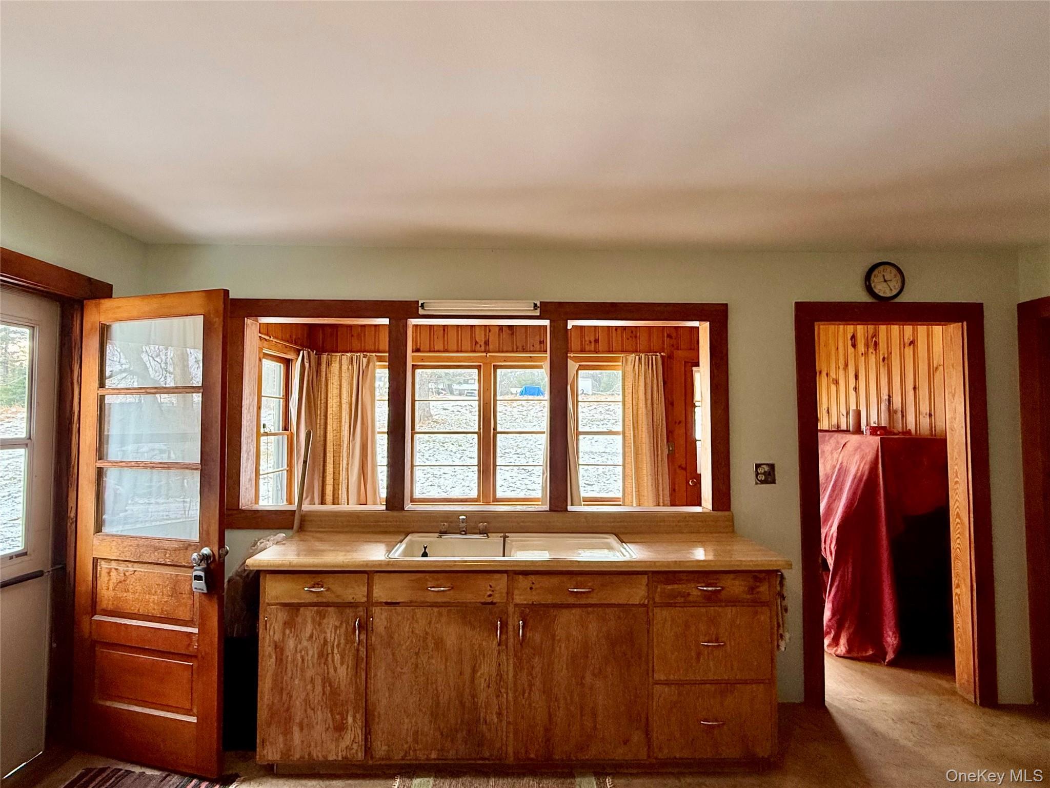 111 Mail Road Barryville, NY 12719 - Photo 13 of 34 Kitchen featuring light countertops and brown cabinetry