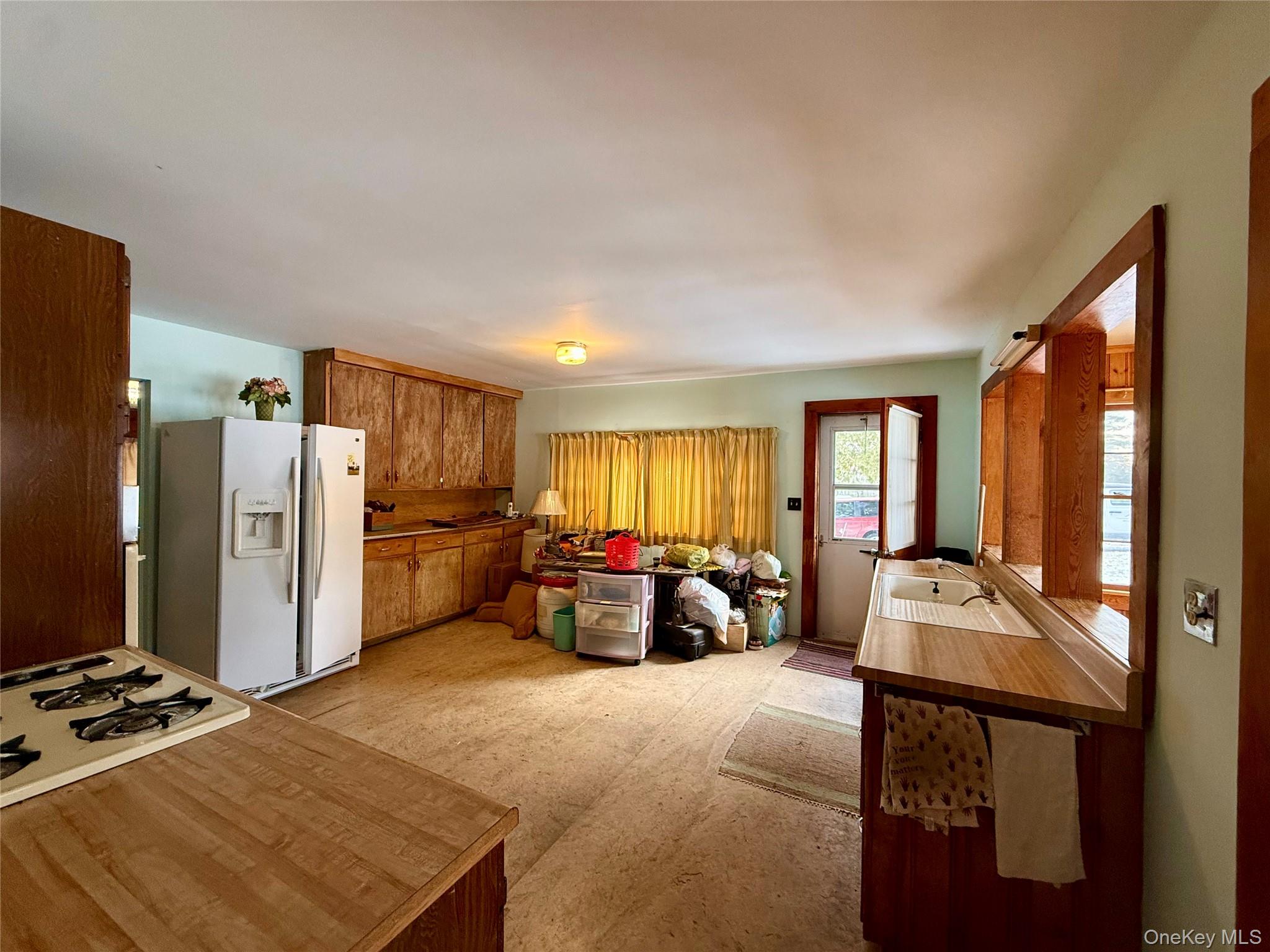 111 Mail Road Barryville, NY 12719 - Photo 15 of 34 Kitchen with brown cabinets, white appliances, and light floors