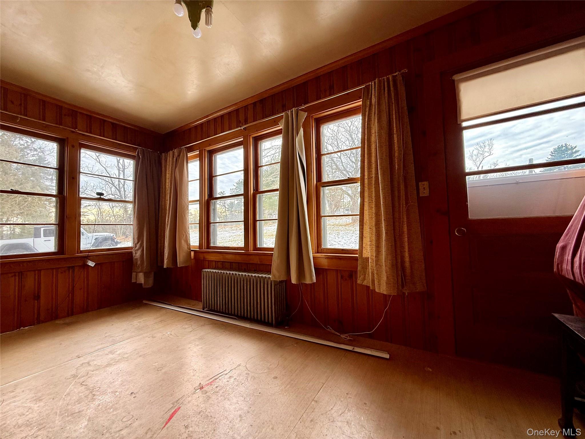 111 Mail Road Barryville, NY 12719 - Photo 16 of 34 Unfurnished room with wooden walls and radiator