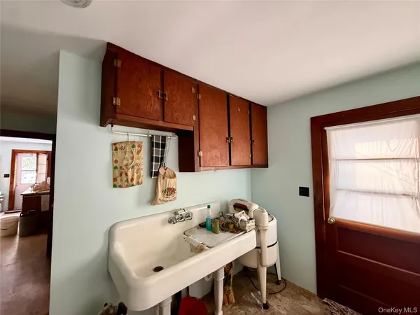 a utility room with dryer washer and a sink