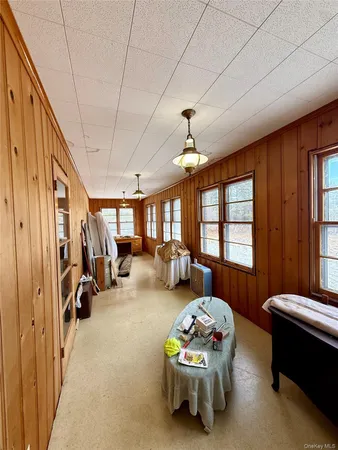 a view of a hallway with furniture