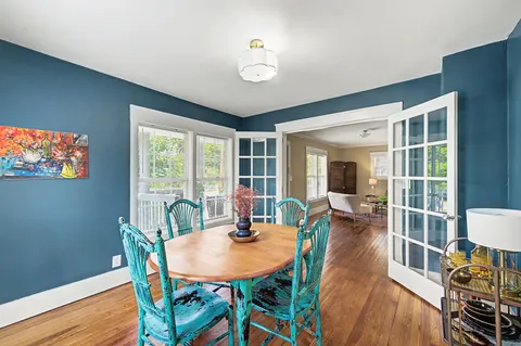a view of a dining room with furniture window and wooden floor