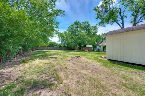 a backyard of a house with lots of green space