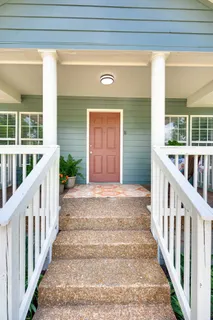 a view of a porch with wooden floor and fence
