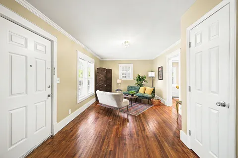 a living room with furniture and wooden floor