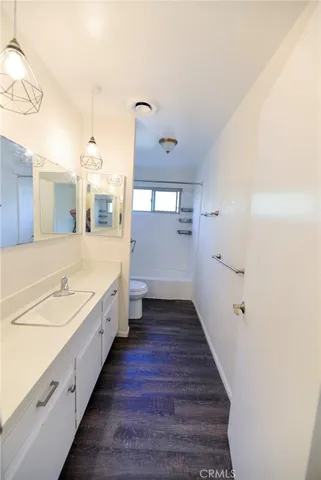 a bathroom with a double vanity sink and mirror with shower
