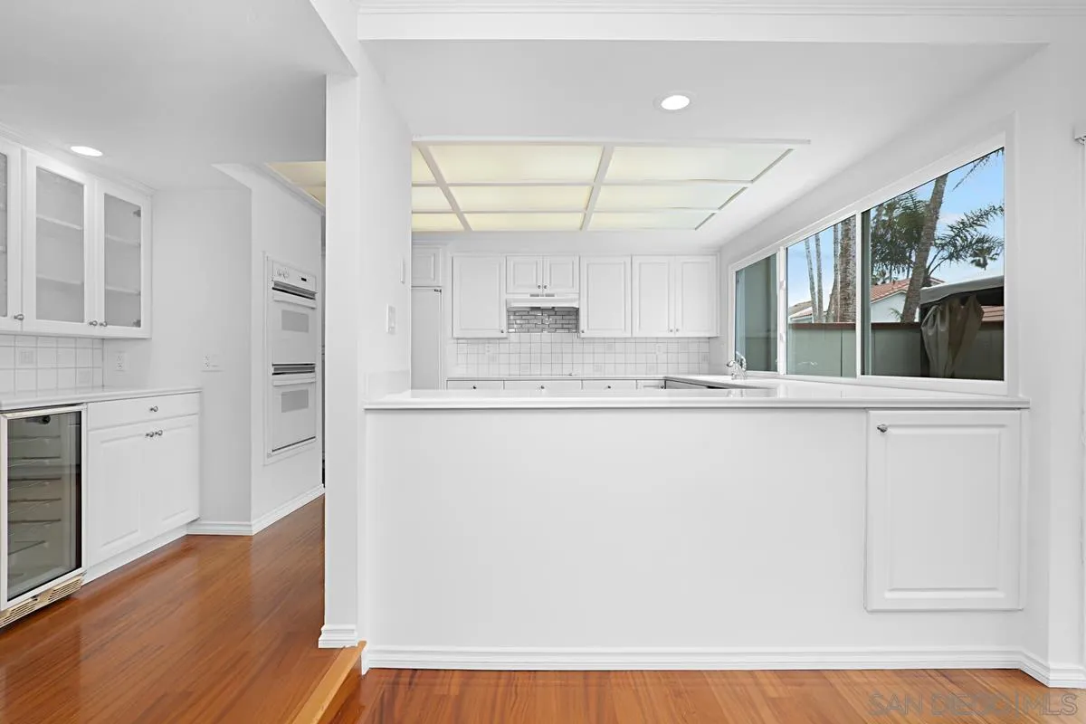 69 Half Moon Bend Coronado, CA 92118 - Photo 14 of 45 a view of kitchen with granite countertop cabinets and wooden floor