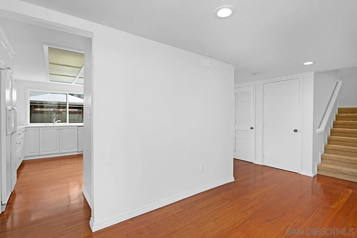 69 Half Moon Bend Coronado, CA 92118 - Photo 10 of 45 a view of an empty room with wooden floor and stairs