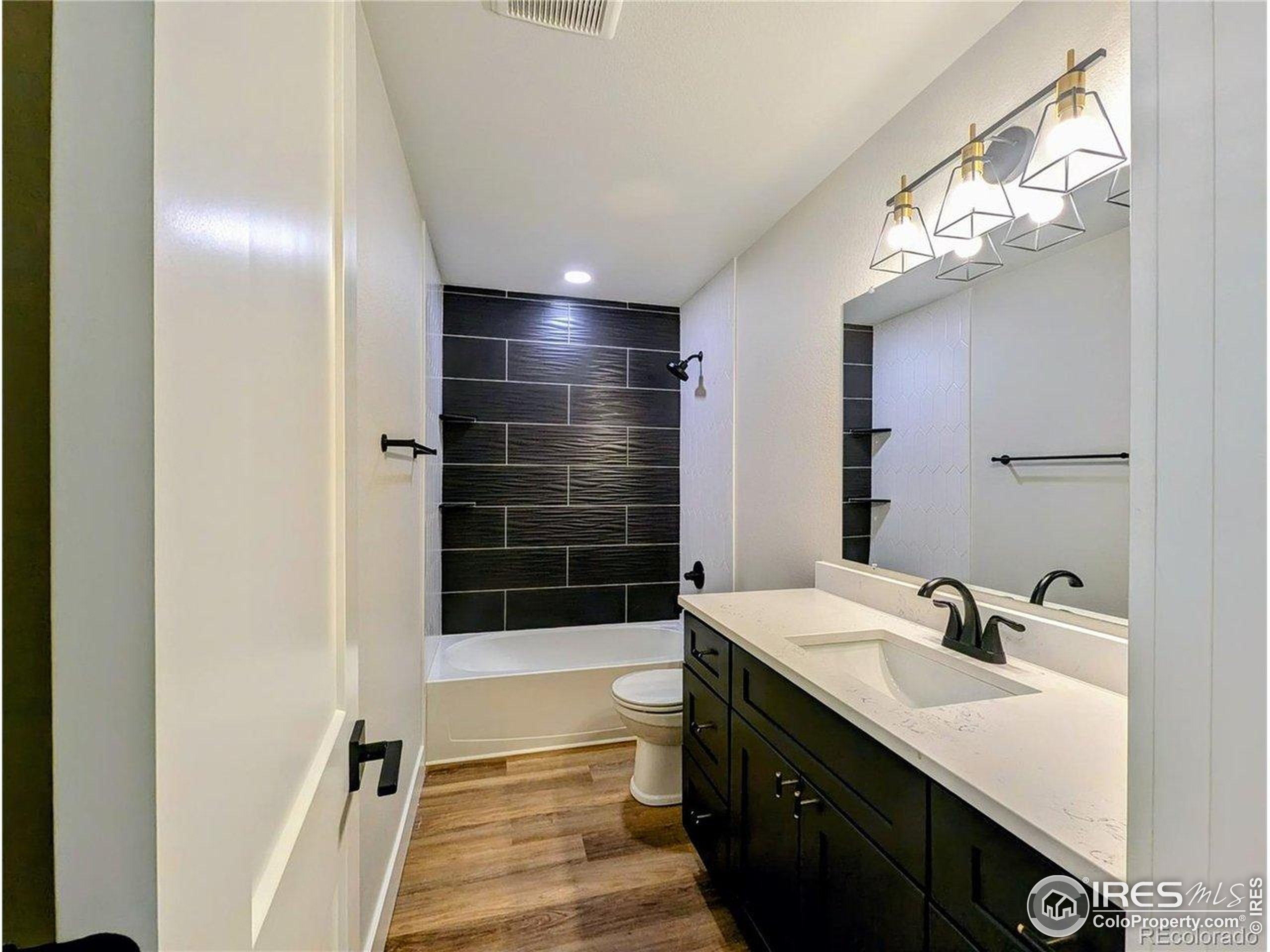 805 Gallup Road Fort Collins, CO 80521 - Photo 11 of 14 a bathroom with a sink a toilet a shower and a mirror