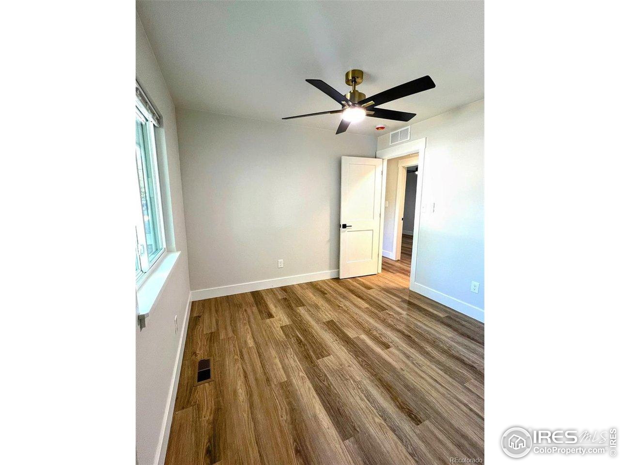 805 Gallup Road Fort Collins, CO 80521 - Photo 9 of 14 a view of empty room with wooden floor