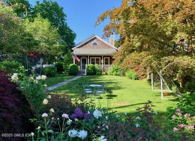 6 Irvine Road Old Greenwich, CT 06870 - Photo 2 of 15 a view of a house with a big yard and potted plants