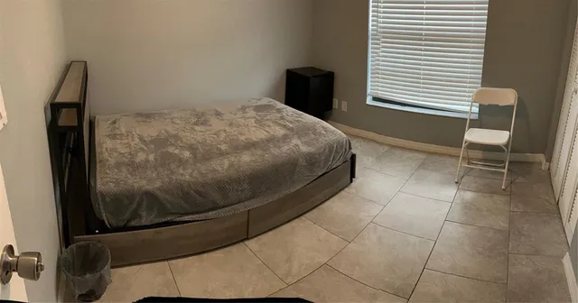 a bedroom with a bed and chair