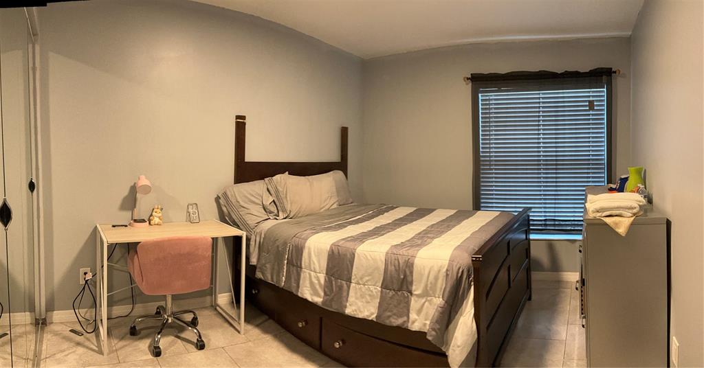 12900 Southwest 13th Manor Davie, FL 33325 - Photo 3 of 6 a bedroom with a bed and dresser