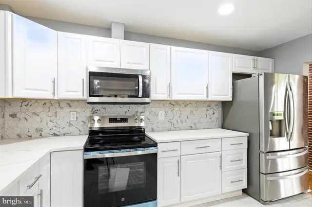 a kitchen with a stove microwave and refrigerator