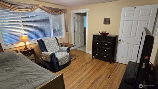 a bedroom with furniture and a flat screen tv