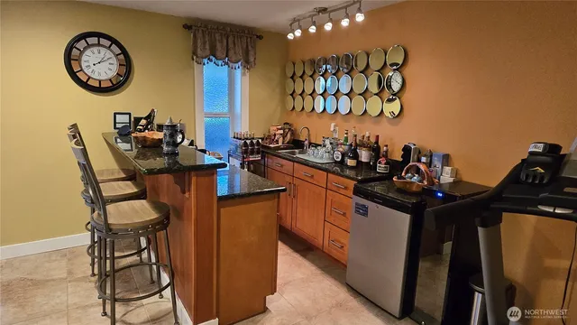 a view of a kitchen with a dining table and chairs
