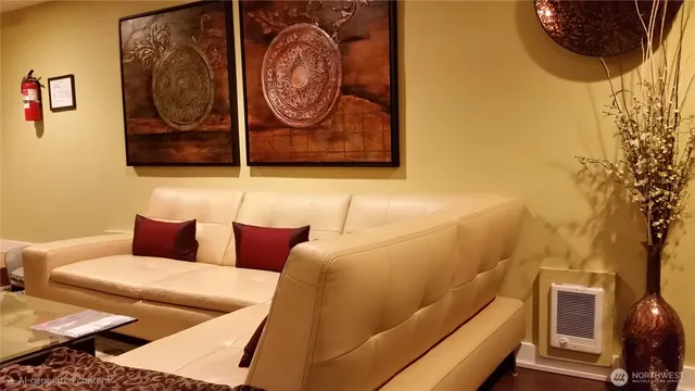 a blue bench sitting next to a white wall