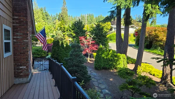 a view of a balcony with wooden floor and fence