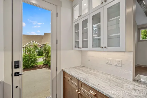 a view of a livingroom with wooden floor and staircase