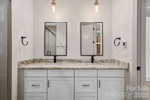 a bathroom with a shower and a sink