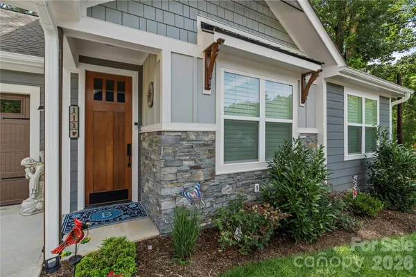 a view of a house with a yard and sitting area