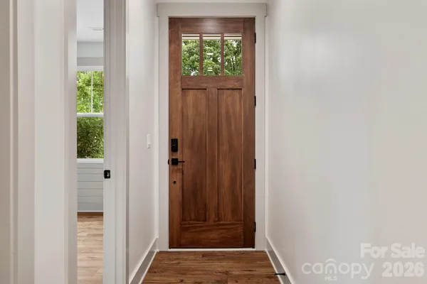 a kitchen with a stove and a wooden floor