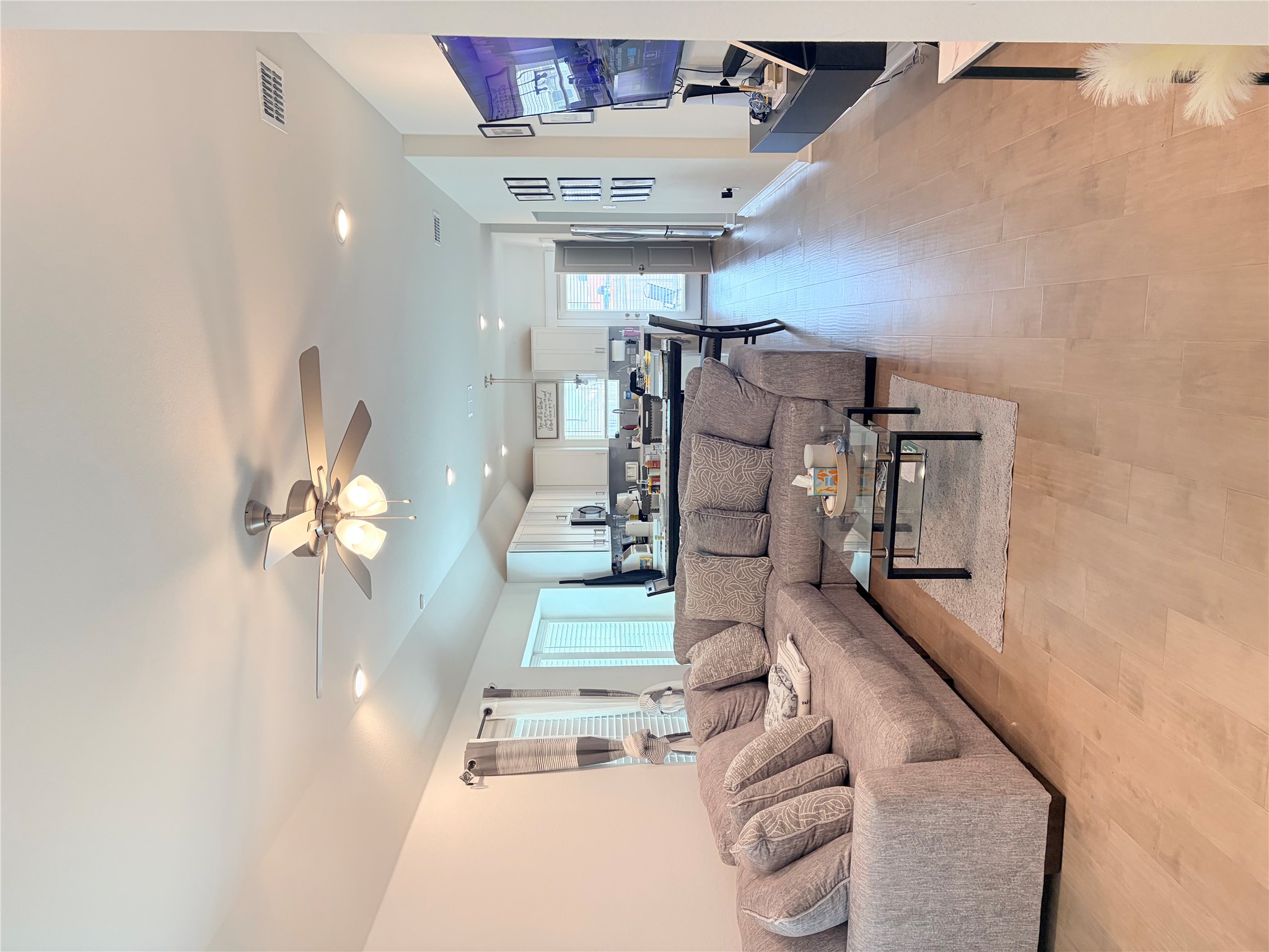182 Shackleton Drive Kyle, TX 78640 - Photo 11 of 12 Living area featuring a ceiling fan, light wood-type flooring, vaulted ceiling, and recessed lighting