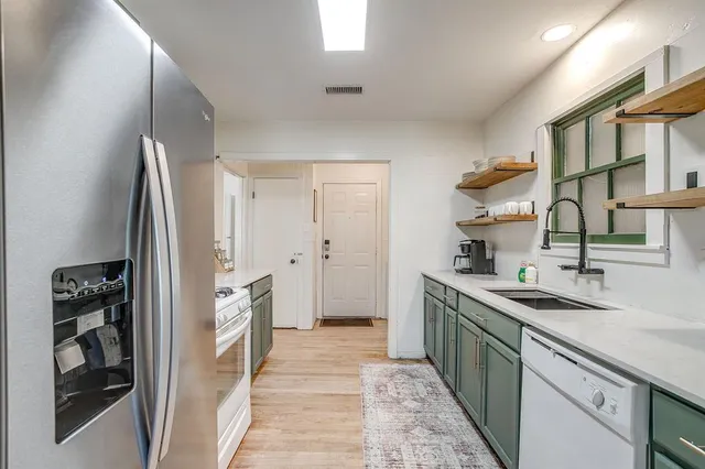 a kitchen with a sink stove and refrigerator