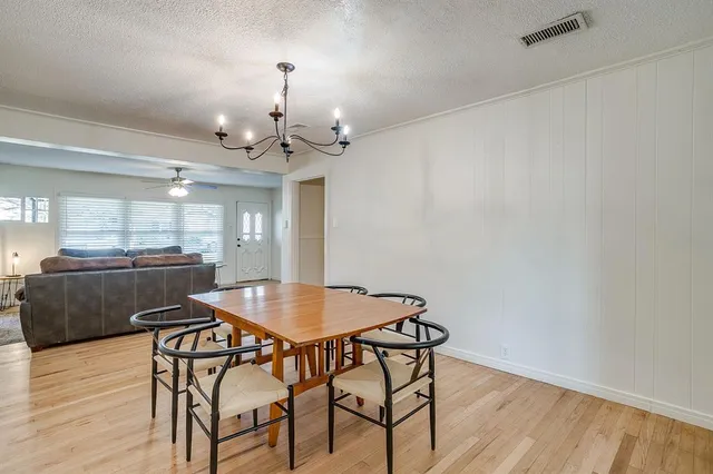 a dining room with furniture and wooden floor