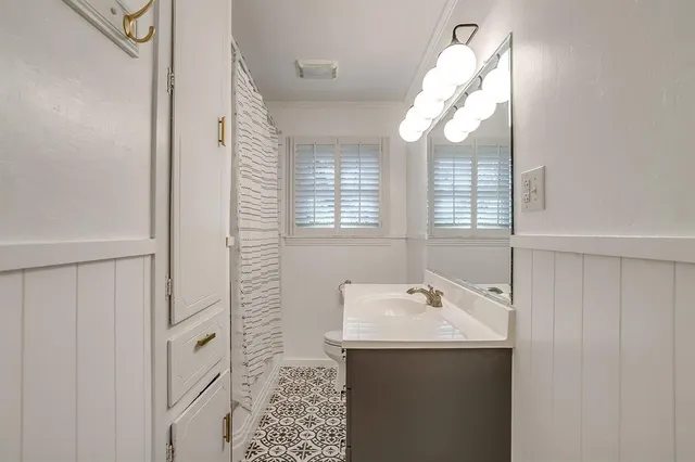 a bathroom with a sink a mirror and a window