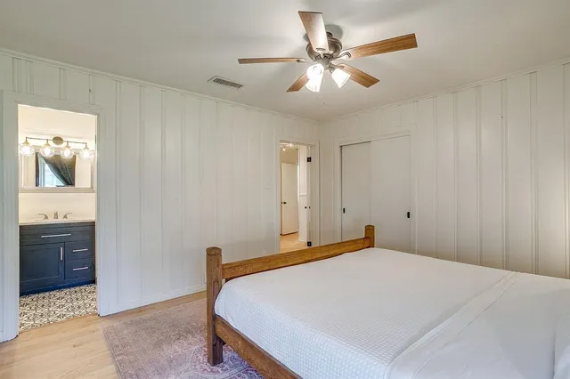 a bedroom with a bed and a chandelier