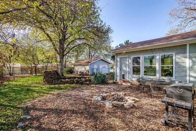 a view of a house with a yard and sitting area