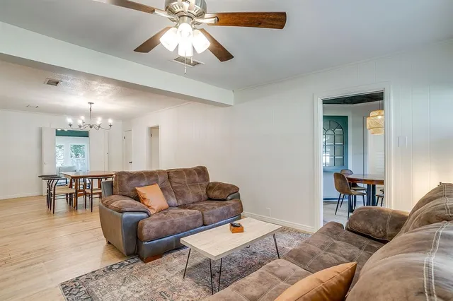 a living room with furniture and a dining table