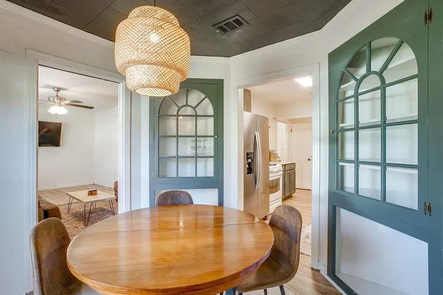 a view of a dining room with furniture and a chandelier