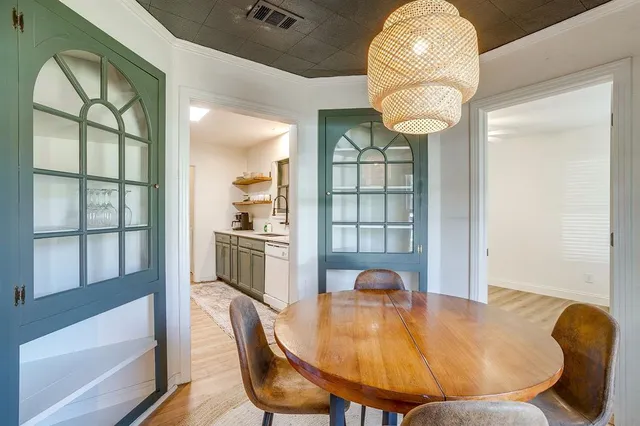 a view of a dining room with furniture wooden floor and chandelier